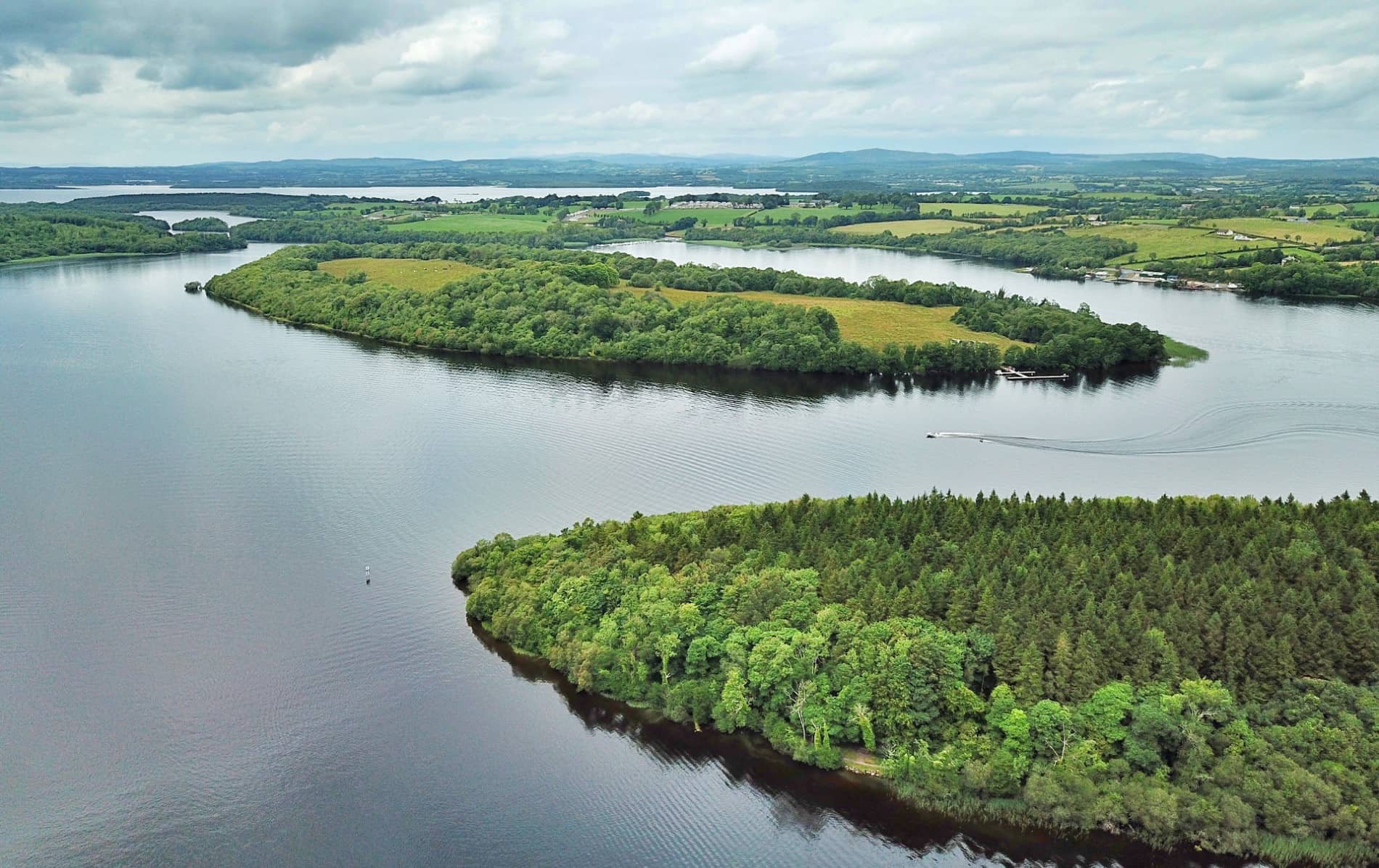 Drone view over Lough Erne with lush green White Island and surrounding lake landscape in Fermanagh.