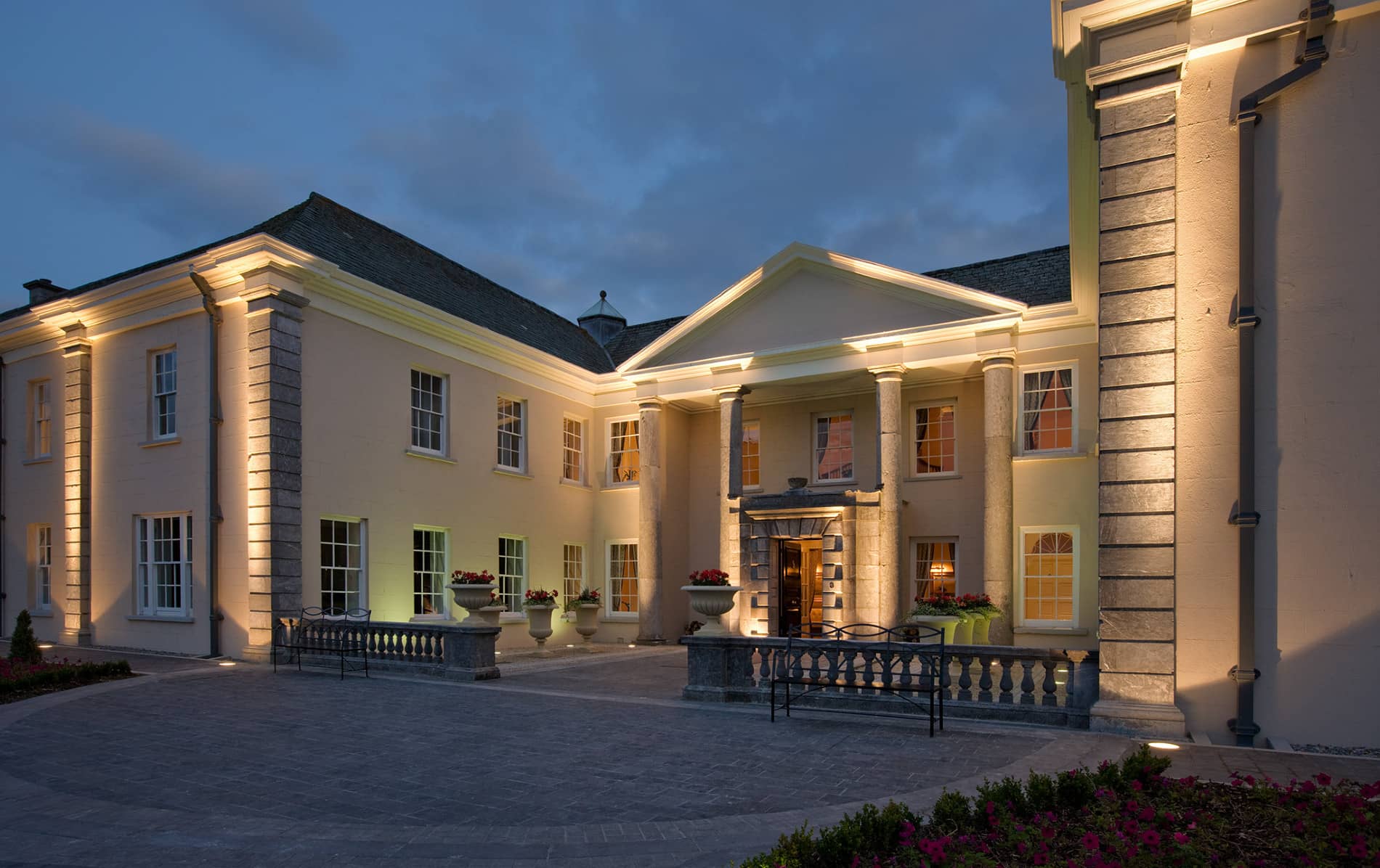 Georgian-style hotel entrance lit at dusk at Castlemartyr Resort in County Cork.