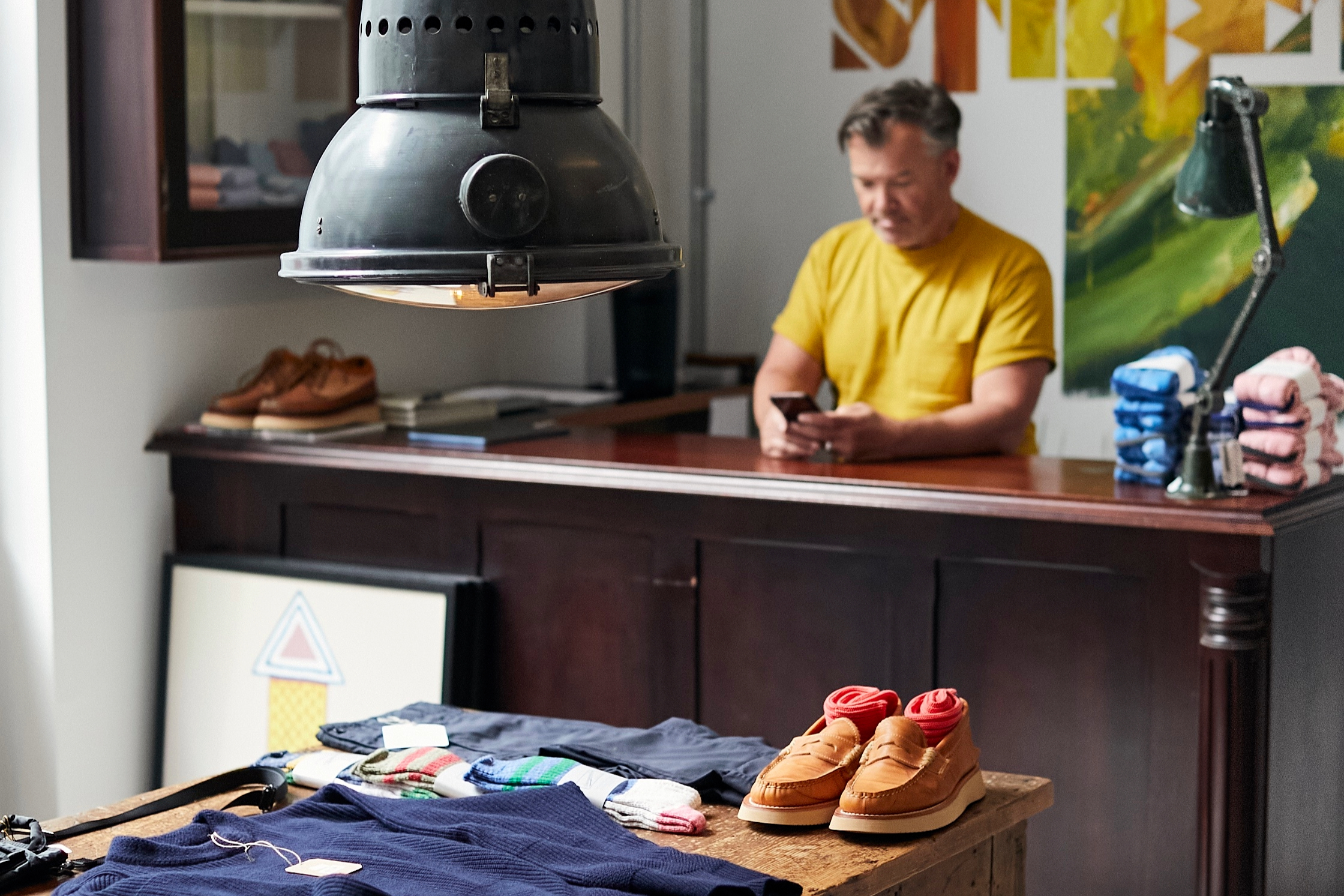 Person browsing clothing and accessories inside a boutique in Belfast's Cathedral Quarter.