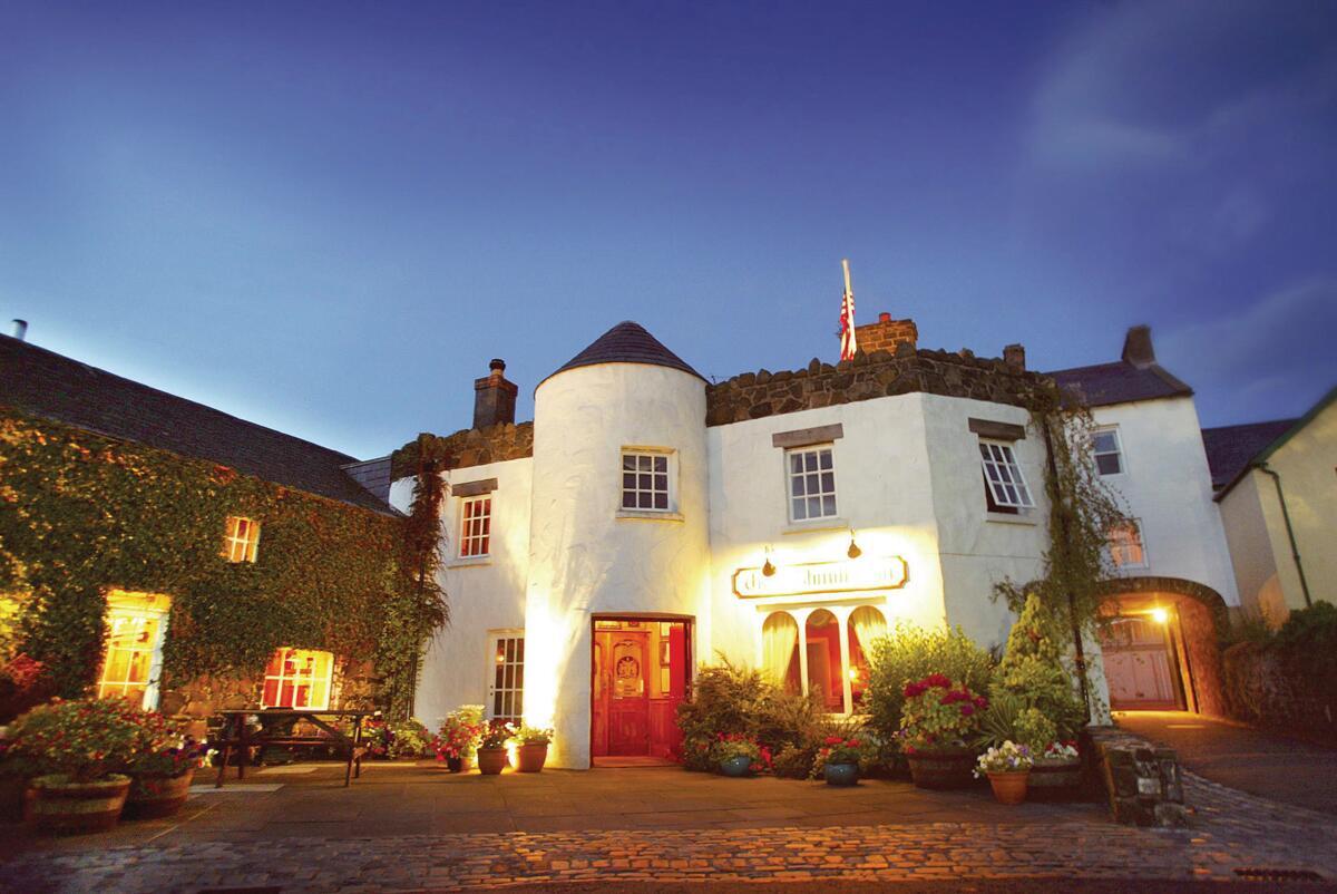 The Bushmills Inn illuminated at dusk in Bushmills, County Antrim.