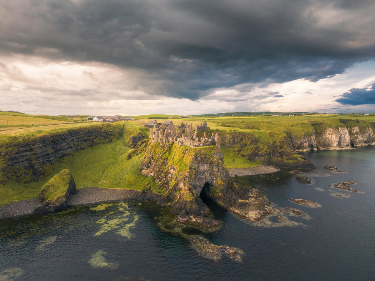 Aerial view of Dunluce Castle on dramatic cliffs above the North Atlantic, County Antrim.