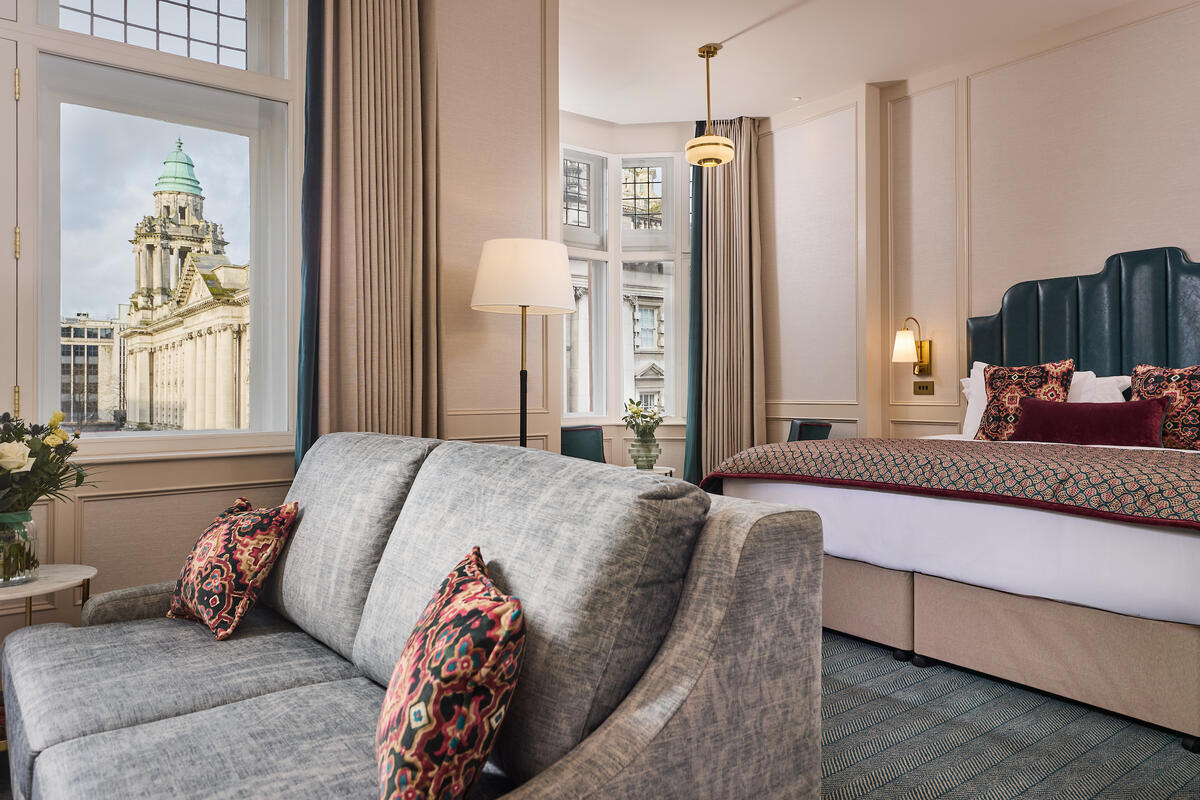 Elegant hotel room at The Bedford Hotel Belfast with Belfast City Hall visible through the window.
