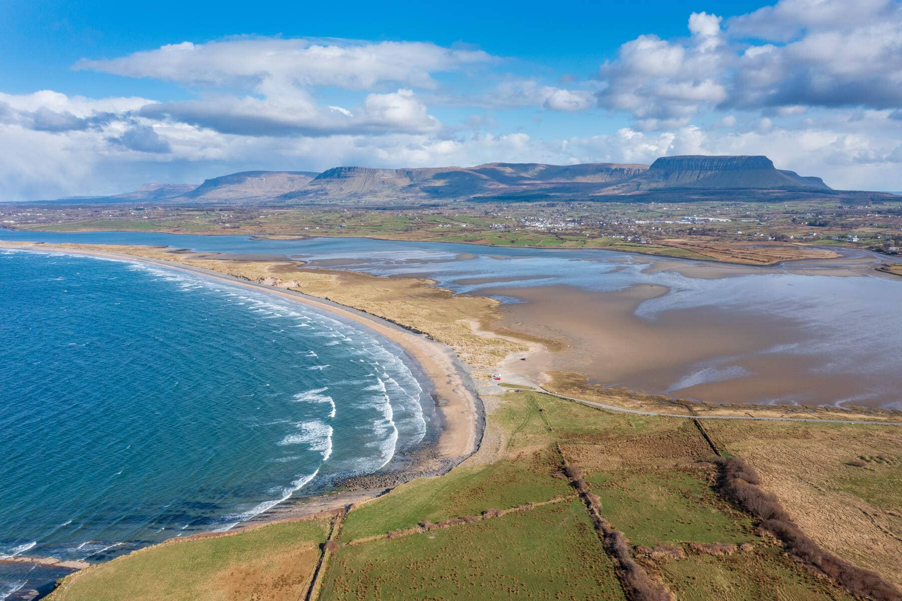 Aerial shot of Streedagh Beach curving along the Atlantic with Ben Bulben mountain in the distance, County Sligo