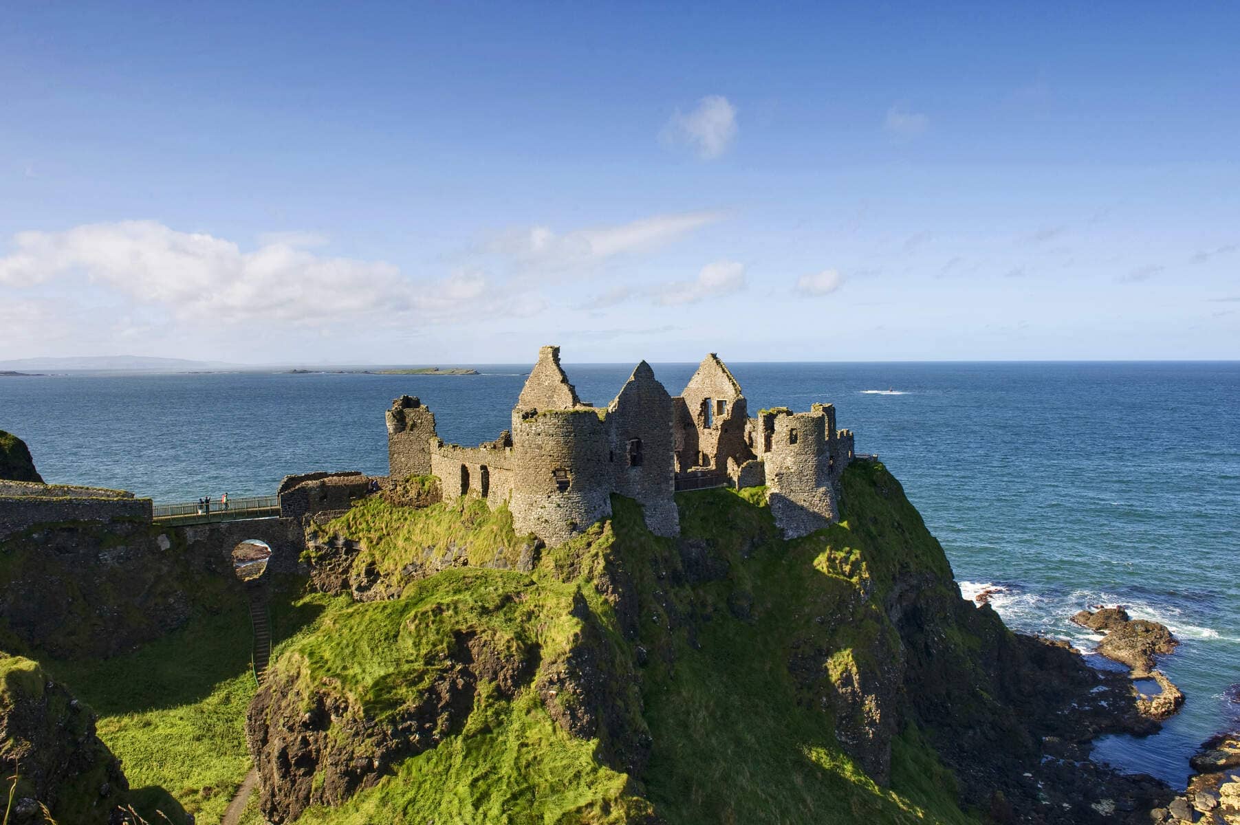 Ruins of Dunluce Castle perched on cliffs above the Atlantic Ocean in County Antrim.