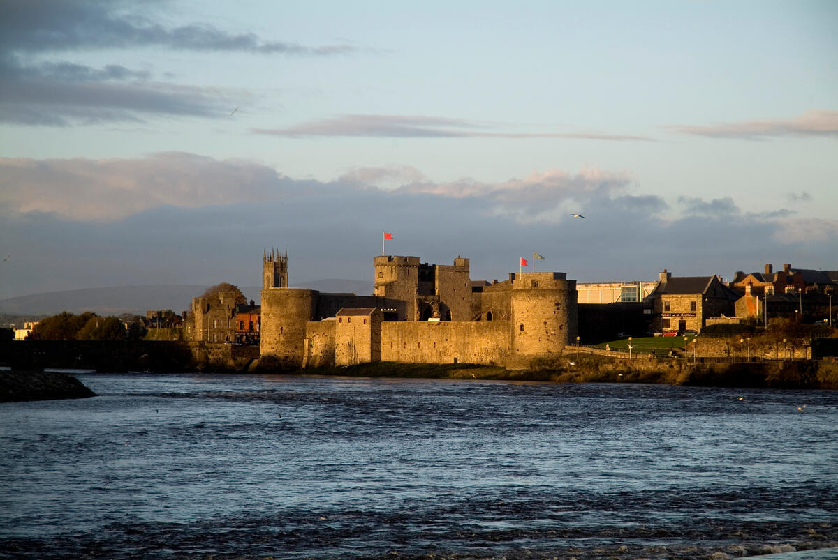 King John's Castle viewed across the River Shannon in Limerick City at sunset.