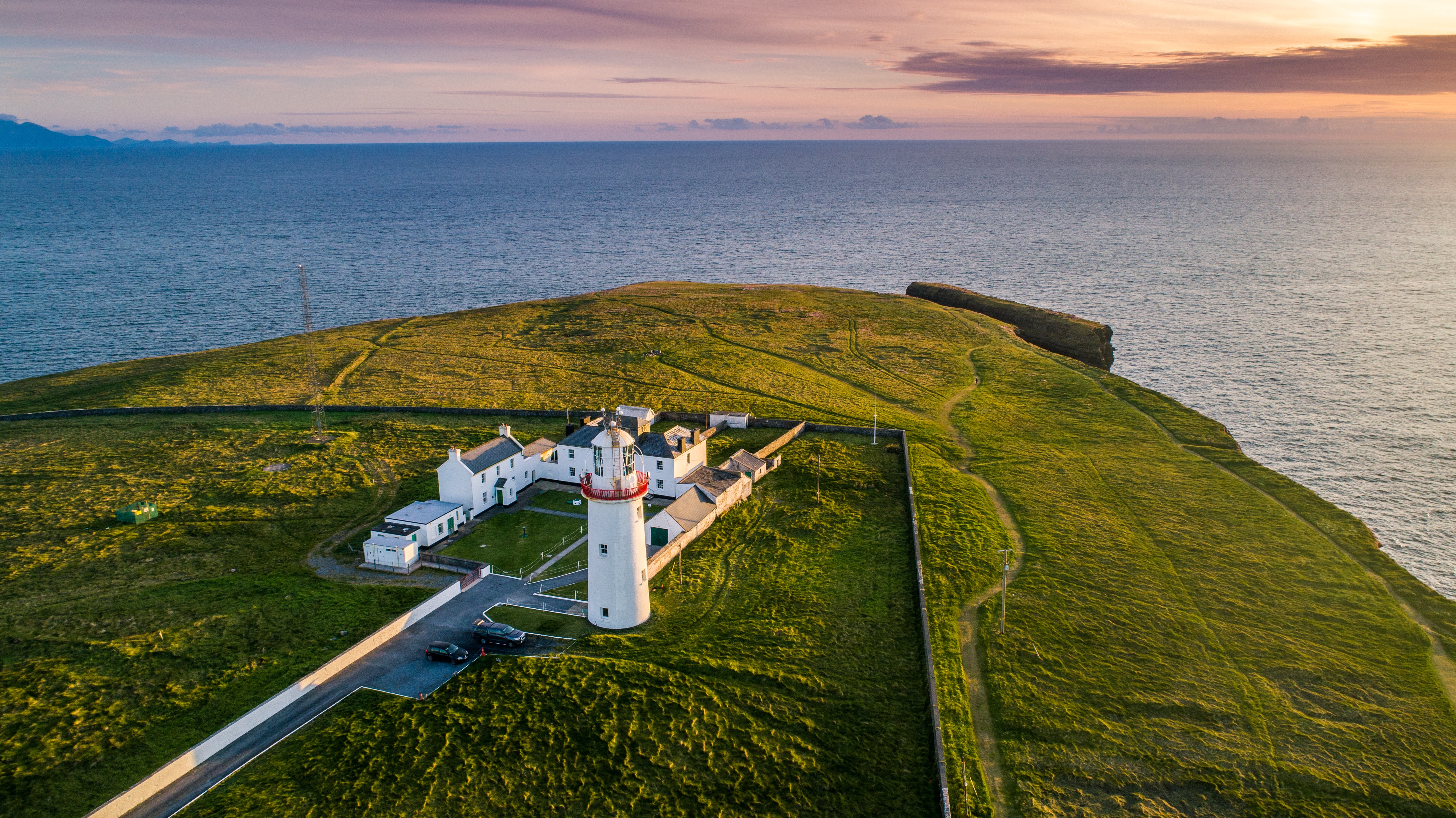 Overhead view of Loop Head Lighthouse on a rugged and green peninsula in County Clare.