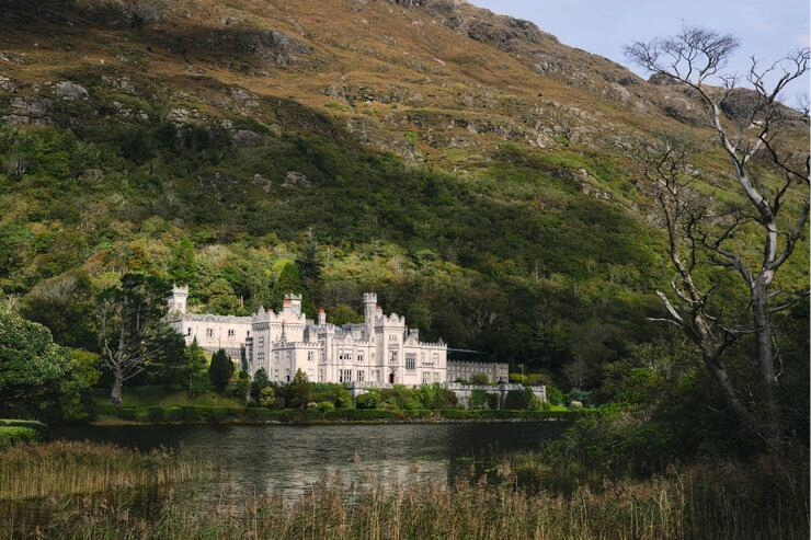 Kylemore Abbey reflected in a lake beneath the mountains of Connemara, County Galway.