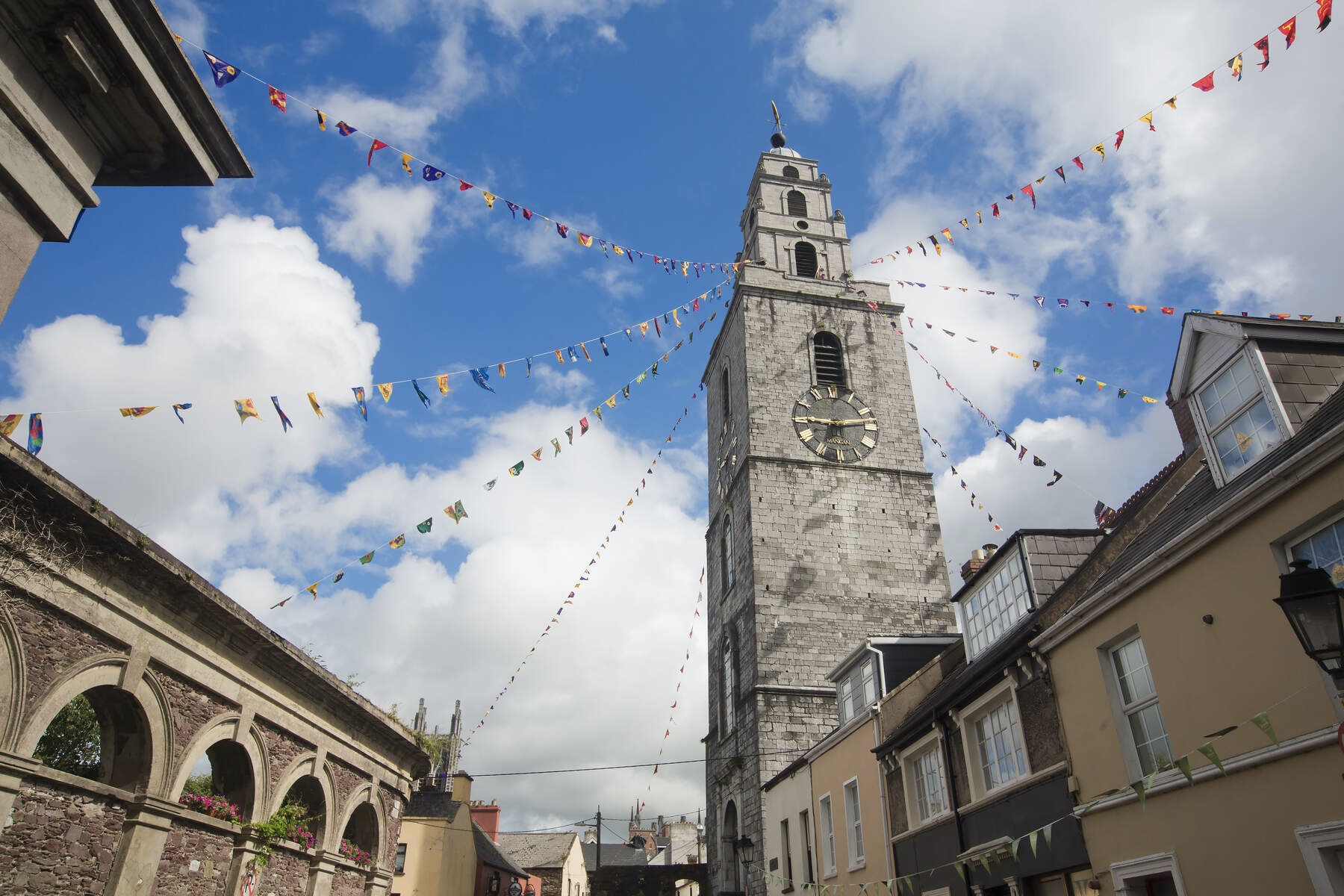 Shandon Bells Tower with colourful bunting under a blue sky in Cork city.