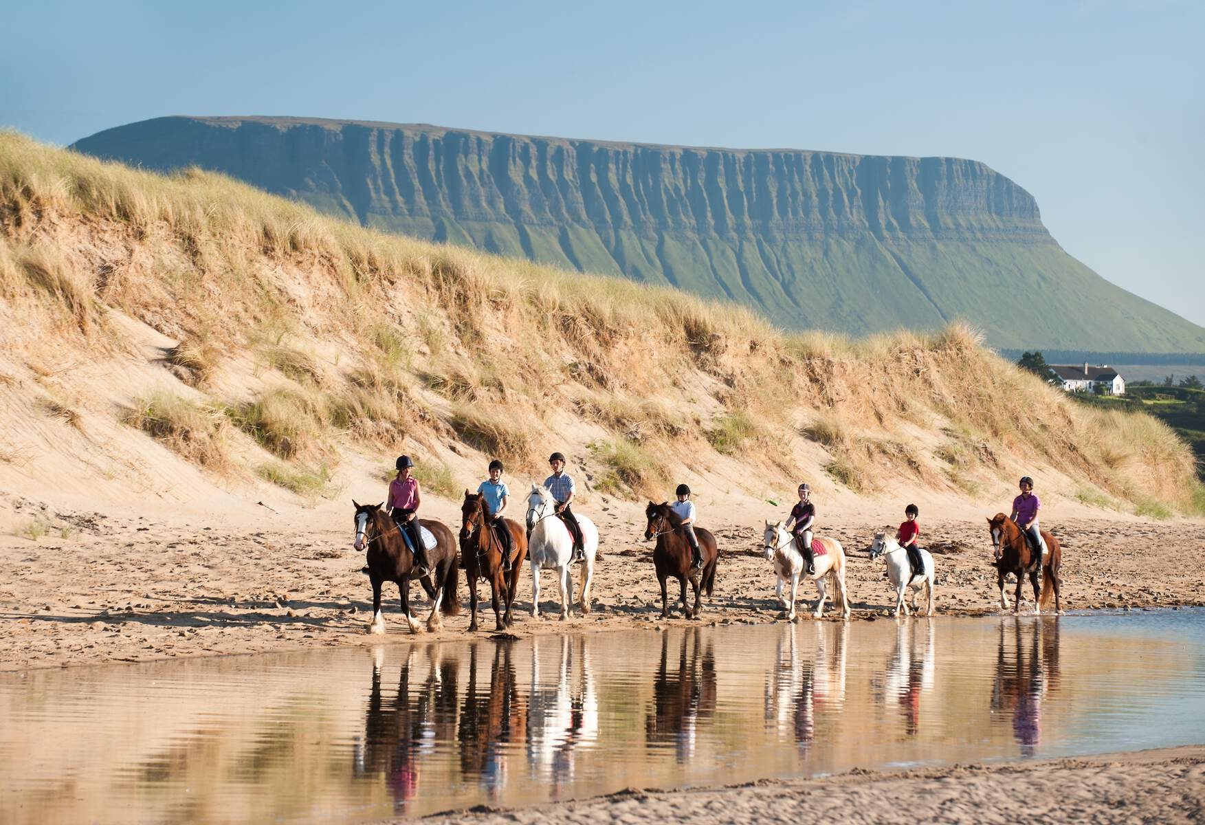 Horse riders on the beach with Ben Bulben mountain in the background, County Sligo.