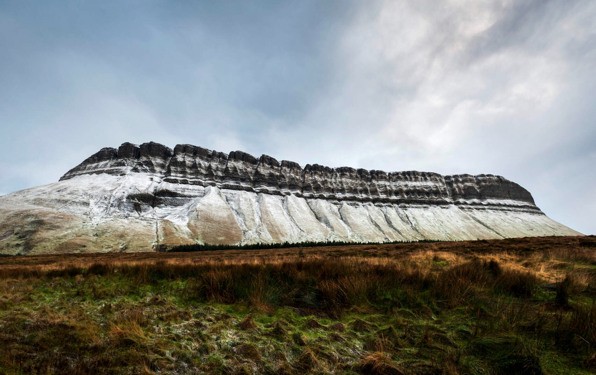 Snow traces the iconic ridges of Ben Bulben in County Sligo under a wintry sky.