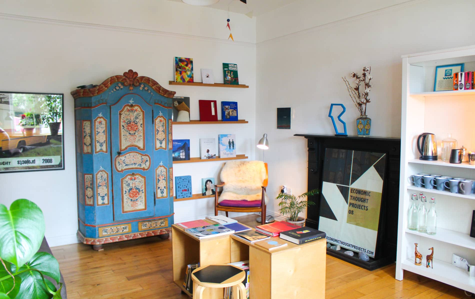 Eclectic sitting room at The Stop B&B in Galway city with blue painted armoire, design books and tea station.