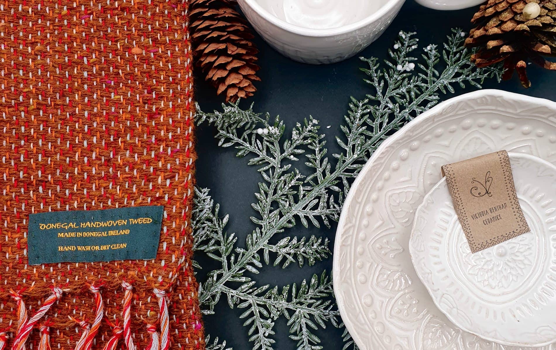 A display of handcrafted Donegal tweed, pine cones, and Victoria Benham ceramics celebrates Irish design and sustainability.