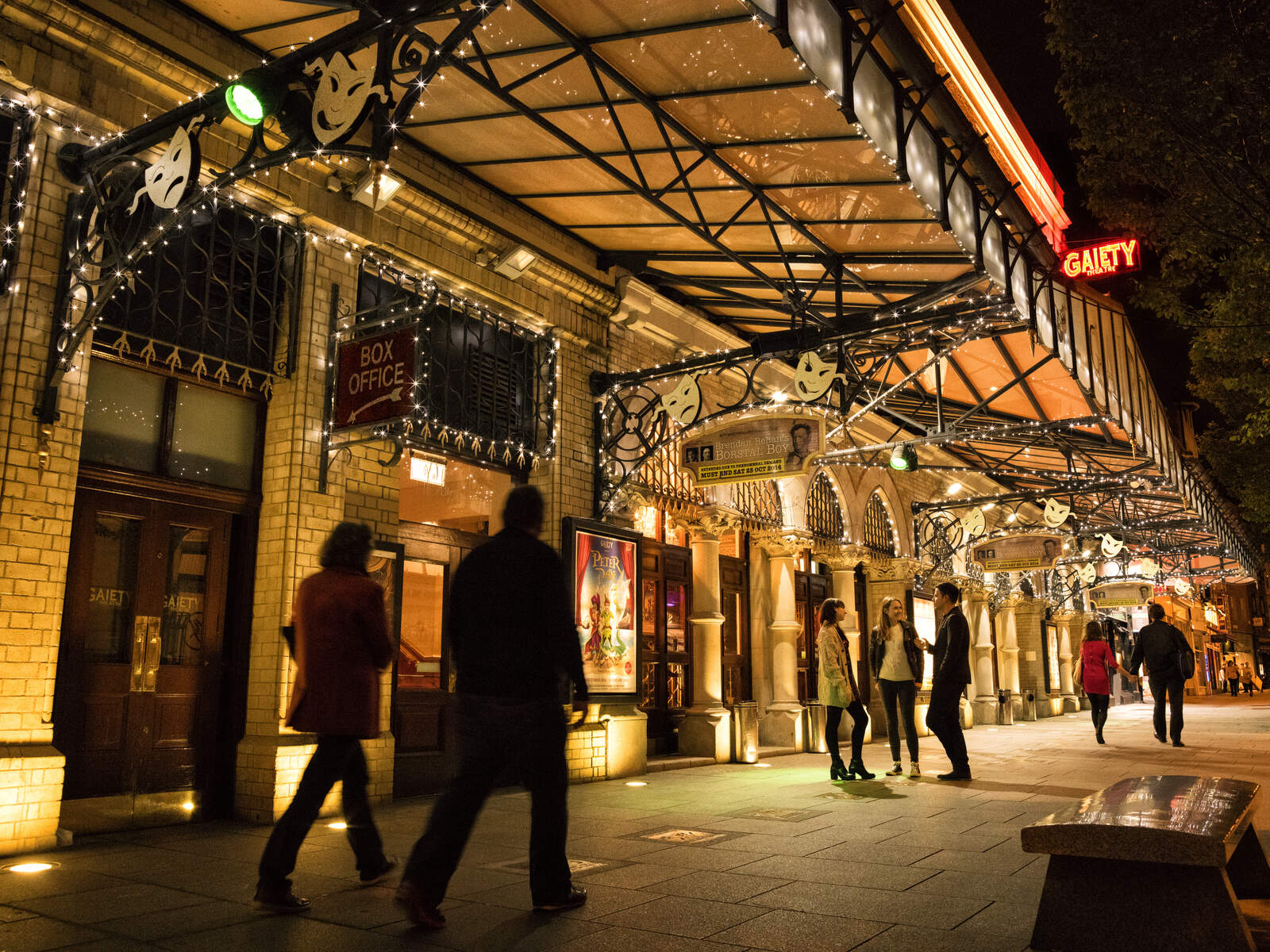 Evening view of the Gaiety Theatre in Dublin lit up with people outside.