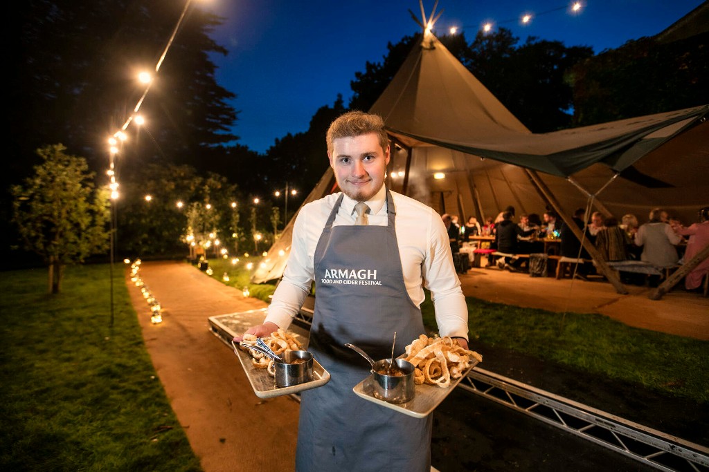 Waiter serving food at Armagh Food and Cider Festival, County Armagh.