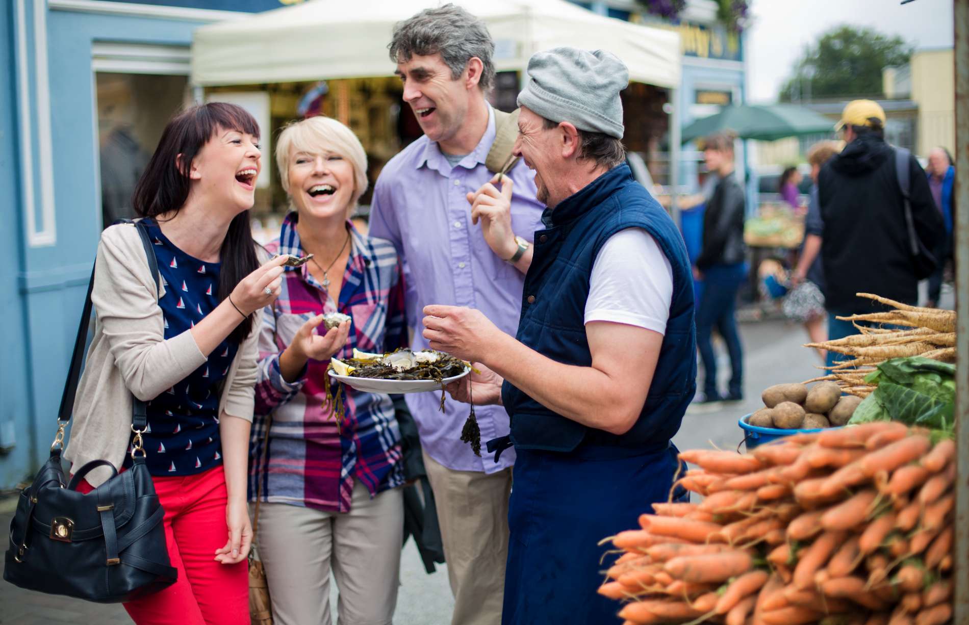 Group enjoying oysters at an outdoor market in Ireland.