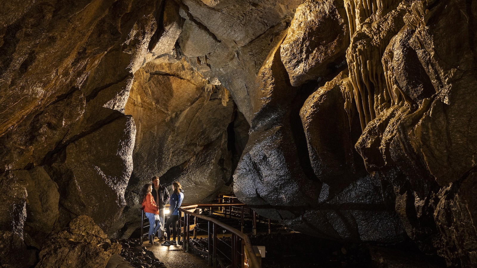 Exploring illuminated limestone chambers in Marble Arch Caves.