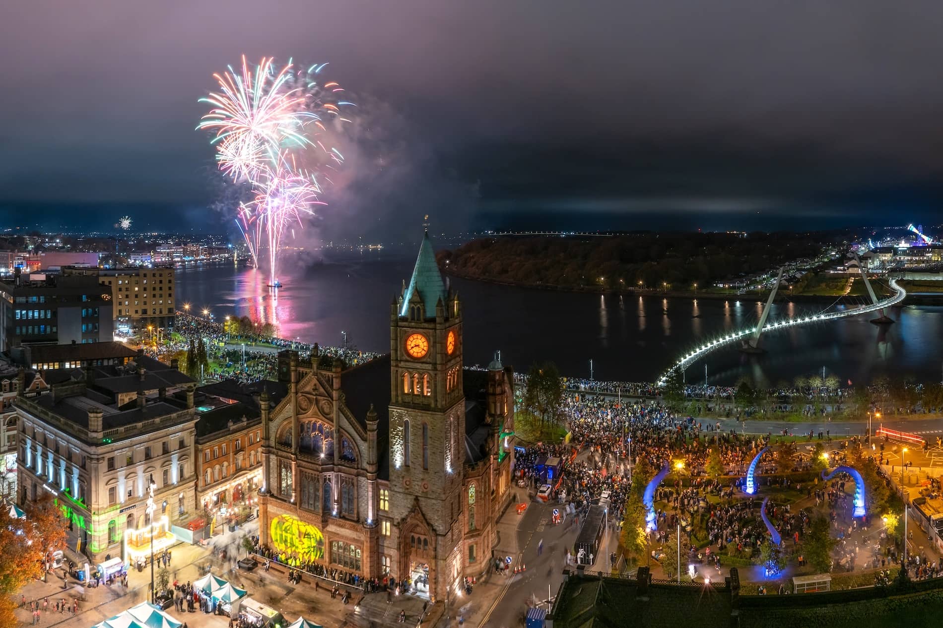 Fireworks over River Foyle and Peace Bridge during Derry Halloween celebrations.