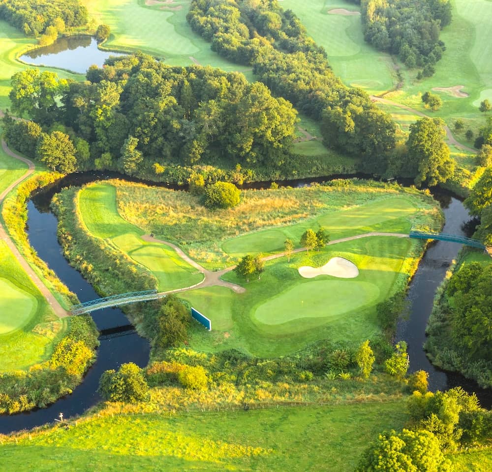 Aerial view of Galgorm Castle Golf Club in County Antrim with river and parkland fairways.