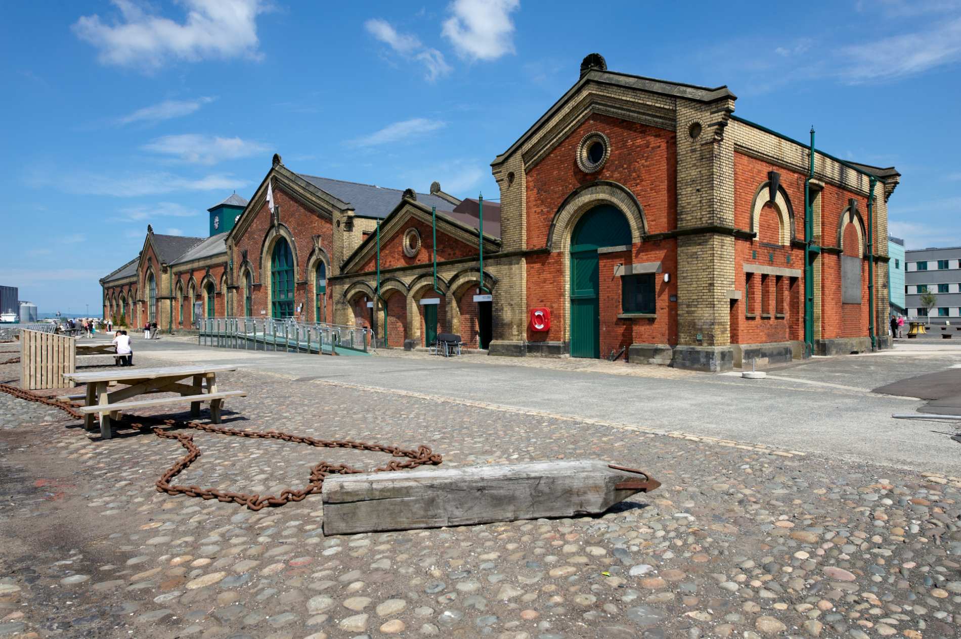Historic red-brick Harland &amp; Wolff building at Titanic Quarter in Belfast on a sunny day.