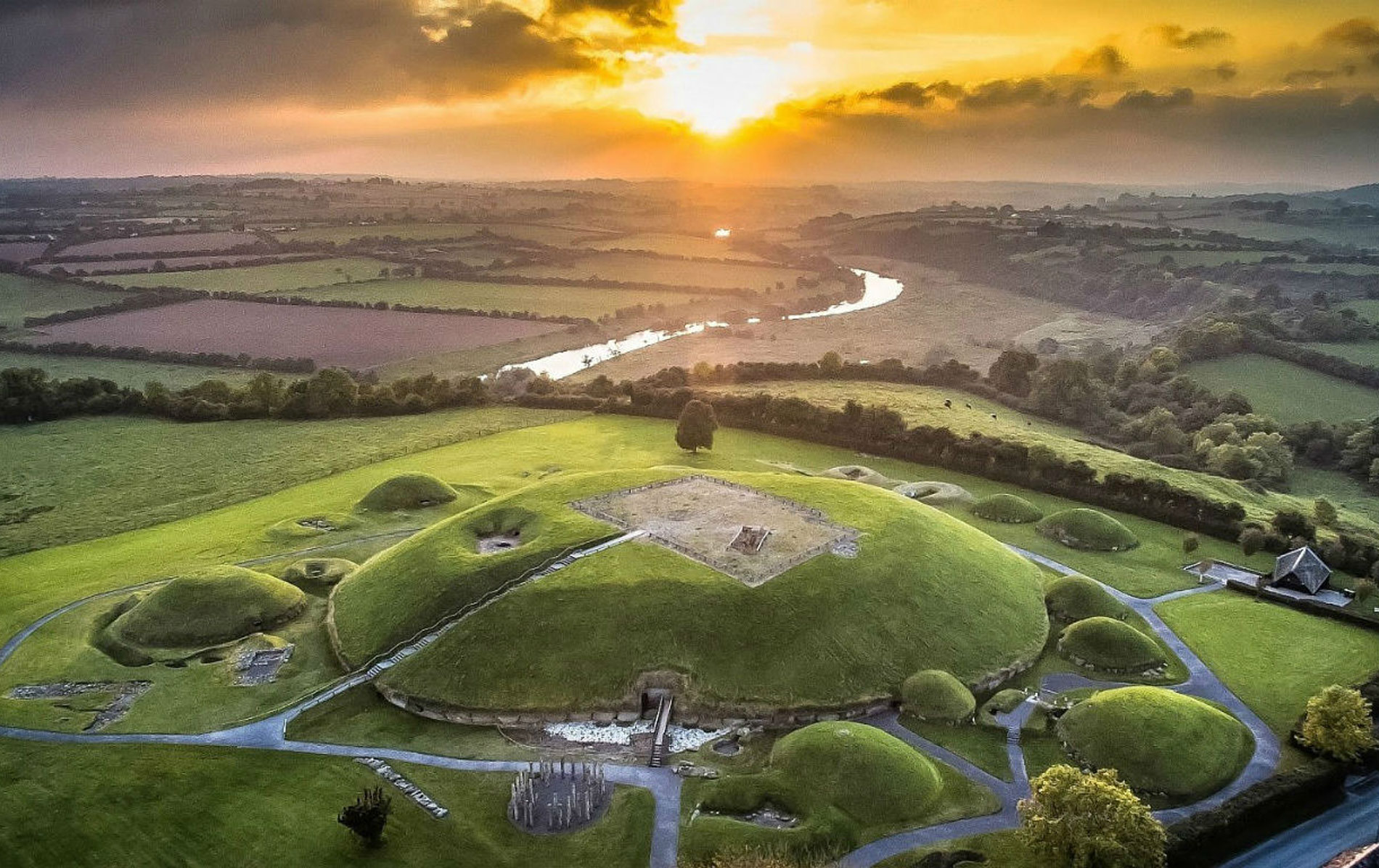 Drone view of Brú na Bóinne passage tombs in County Meath at sunrise, a UNESCO World Heritage Site.