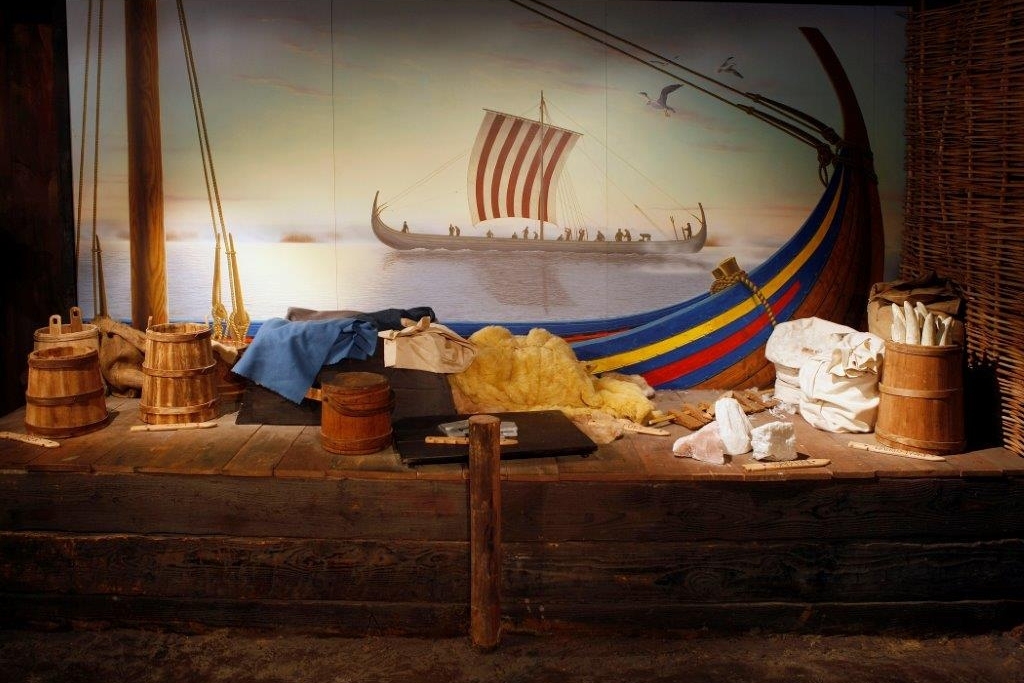 Exhibit of a Viking longship with colourful sail and tools at the Dublinia Viking Museum, Dublin.