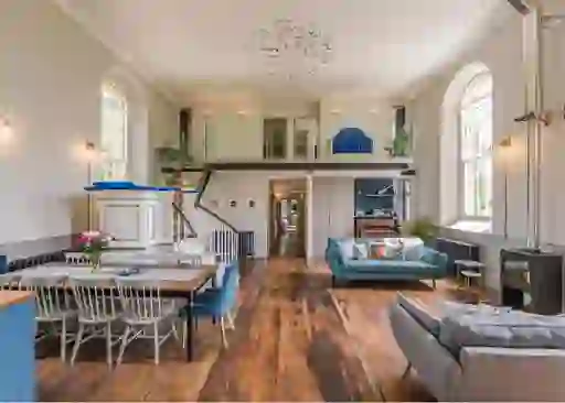 Bright open-plan living space in a converted church with mezzanine bedroom in County Down.