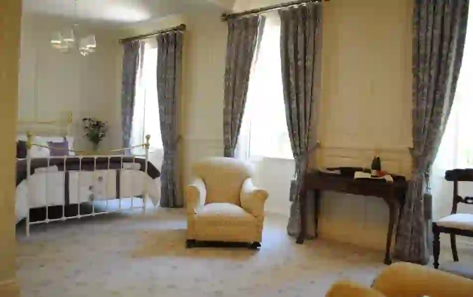 Bright period-style bedroom at cosy Killiane Castle in County Wexford, with champagne and floral décor.