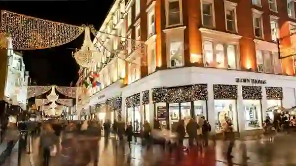Crowds shopping under Christmas lights on Grafton Street outside Brown Thomas, Dublin.