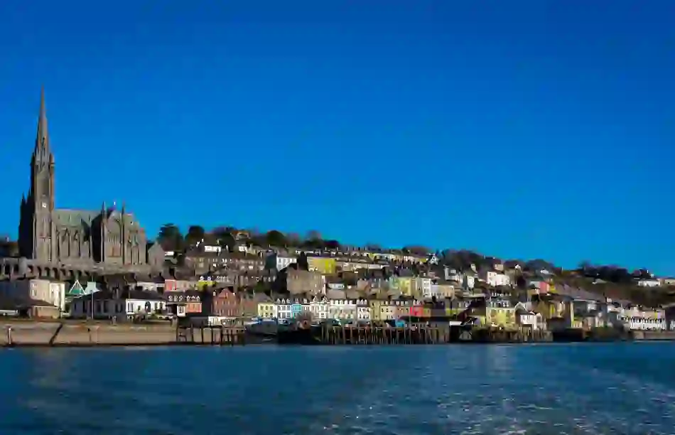 St Colman’s Cathedral towers above the colourful hillside houses of Cobh, viewed from across the water.