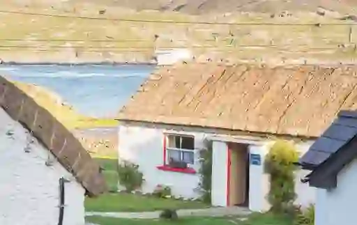 Thatched cottage with whitewashed walls at Glencolmcille Folk Village, County Donegal.
