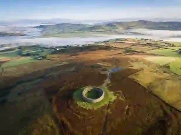 Grianán of Aileach stone ringfort on a hilltop with sweeping views of valleys in County Donegal.