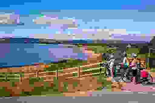 Cyclists admiring the sea views along the Waterford Greenway.