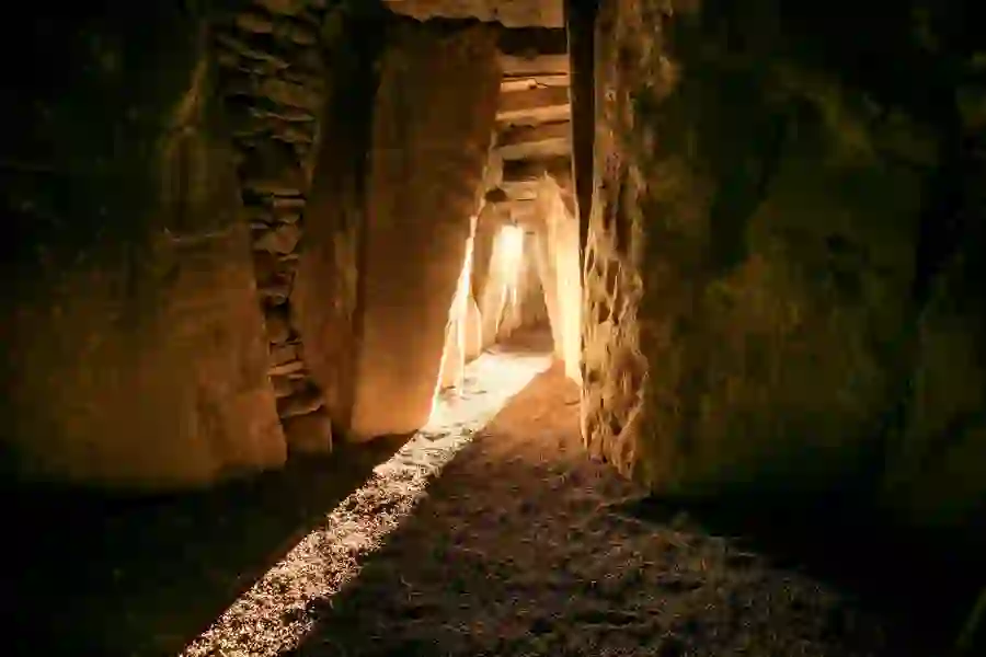 Sunlight streaming along the stone passageway inside Newgrange’s ancient burial mound.