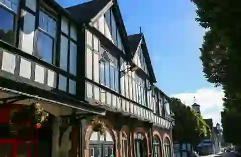 Black and white Tudor-style building with large windows in a sunny street in Dublin.