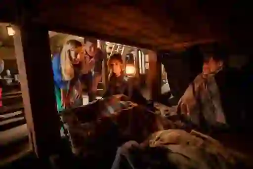 Visitors explore the dimly lit cabin of the Dunbrody Famine Ship in County Wexford beside costumed interpreters.