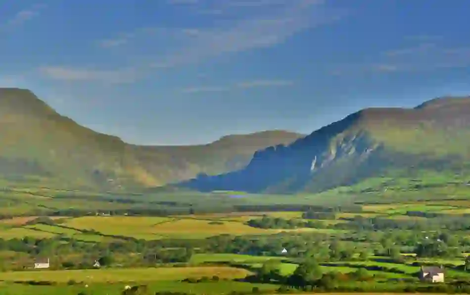 Green valley and mountain views at Annascaul Lake in County Kerry.