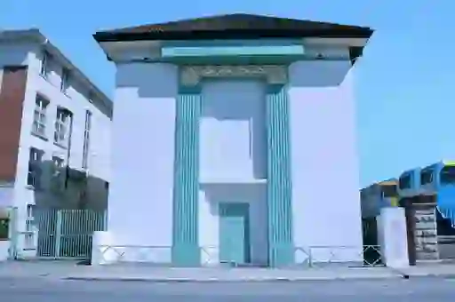 White Art Deco facade of Windmill Lane Studios, with turquoise trim and clear blue sky in Dublin.