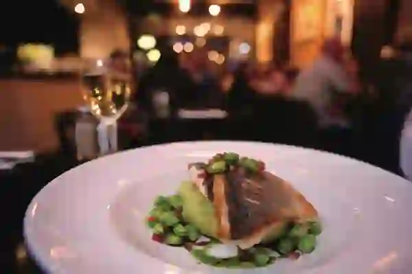 Pan-fried fish with peas and mash served with white wine in Mourne Seafood Bar, Belfast.