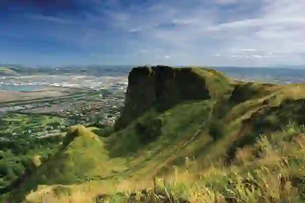 View from Cave Hill in Belfast with grassy cliffs overlooking the city and coastline.