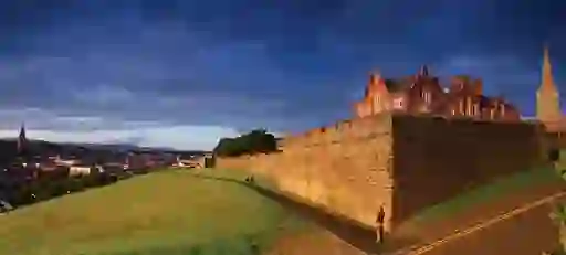 View from the historic Derry~Londonderry walls overlooking the city and redbrick Guildhall.