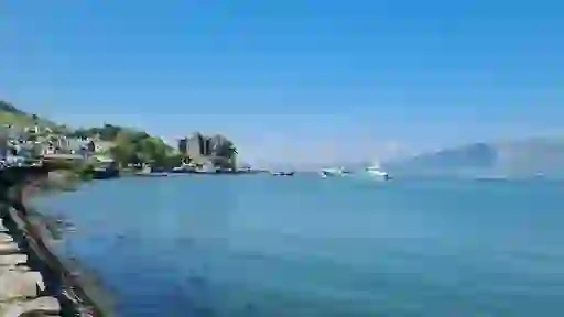 Carlingford village and King John’s Castle seen from the harbour with boats on Carlingford Lough.