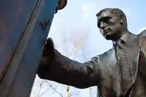 Close-up of the CS Lewis statue in Belfast’s CS Lewis Square, depicting the writer opening a wardrobe door.
