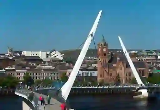 The modern Peace Bridge in Derry~Londonderry arcs over the River Foyle, linking Ebrington Square and the city centre.