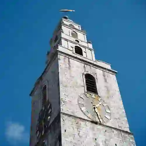 Shandon Bells clock tower in Cork City, historic landmark with fish weathervane against clear blue sky.