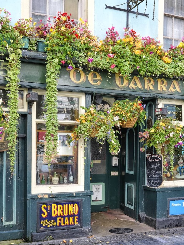 De Barra’s pub exterior in Clonakilty, West Cork, with colourful flowers and traditional Irish façade.