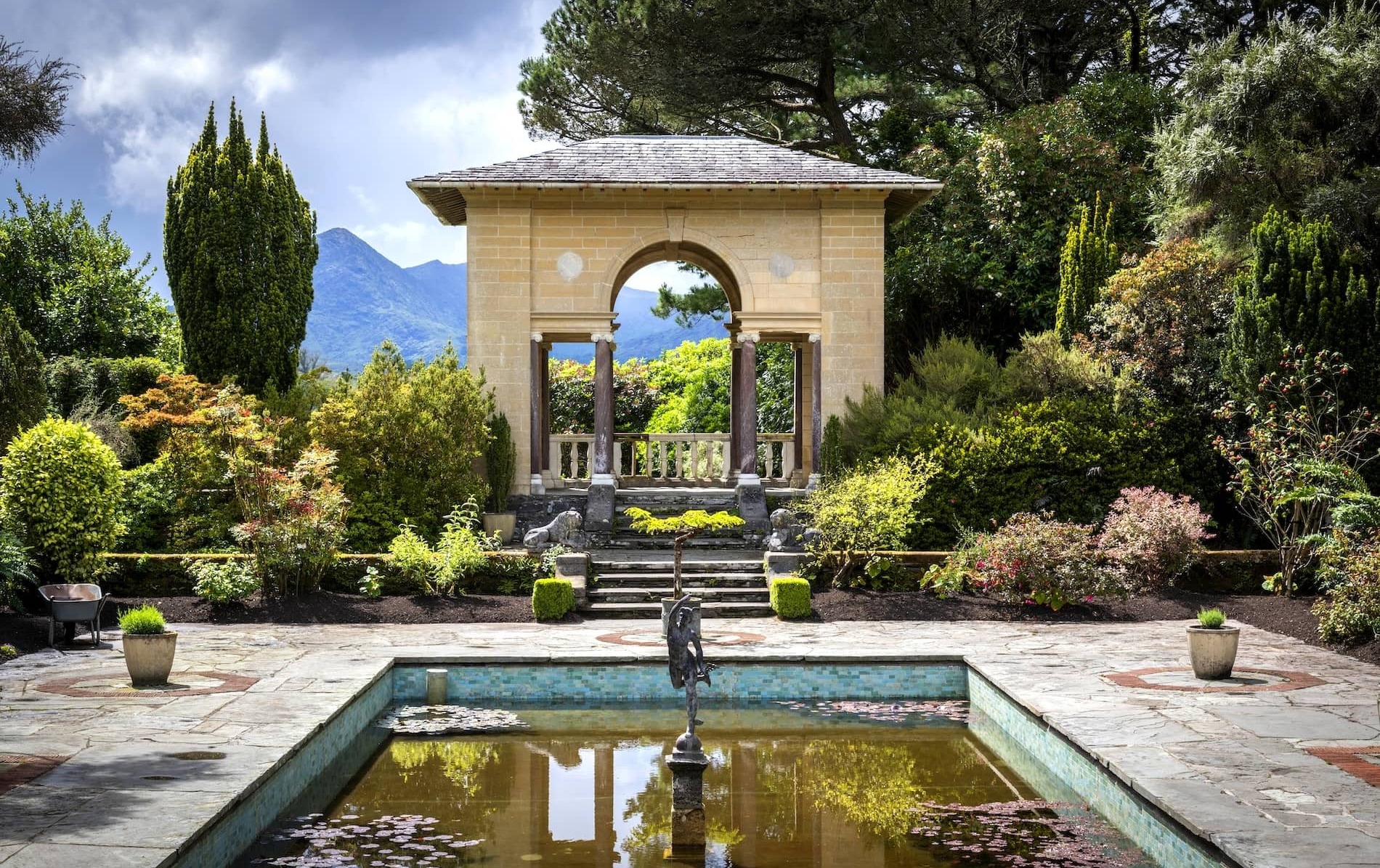 Italian gardens on Garnish Island, West Cork, with pavilion, fountain and mountain views in lush setting.