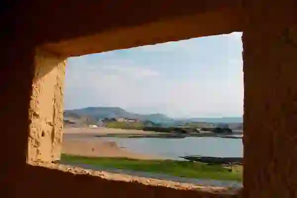 Looking out at Bundoran Beach in County Donegal from a concrete window on a sunny, blue-sky day.