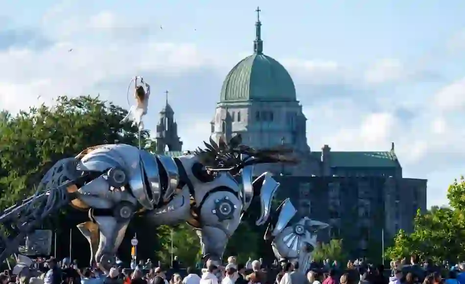 Large mechanical horse parade sculpture performing in Galway city with Galway Cathedral in the background.