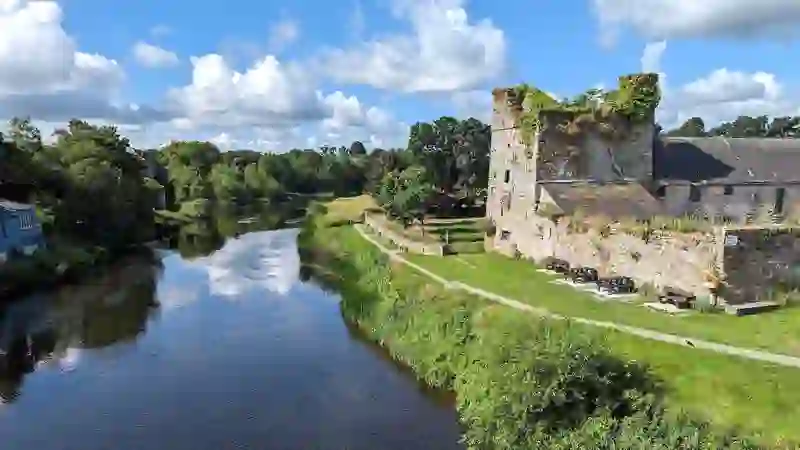 Sweetman Castle beside the River Nore with riverside path and greenery in Kilkenny.