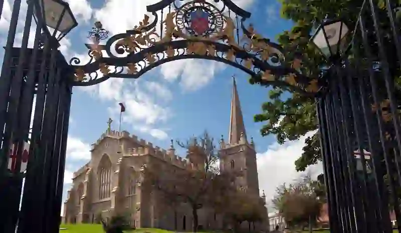 St Columb’s Cathedral and spire viewed through decorative gates in Derry~Londonderry.